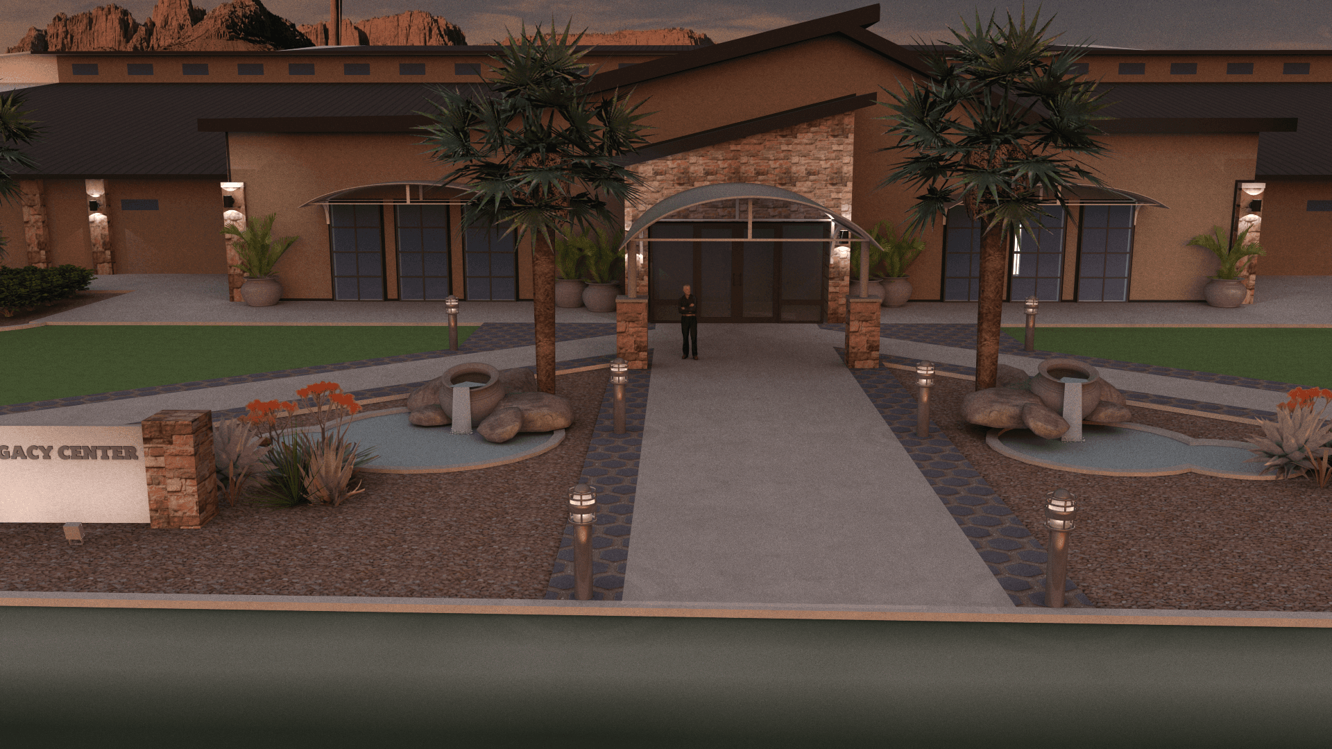 The Legacy Center's arched main entrance lit at dusk